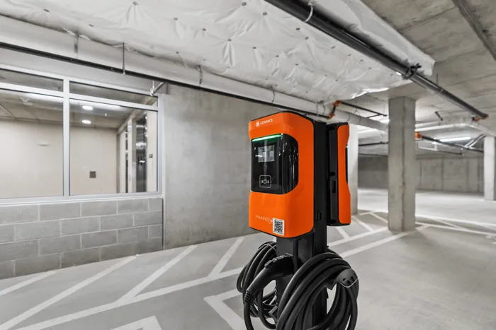 Modern electric vehicle charging station in a sleek, spacious parking garage, showcasing eco-friendly convenience.
