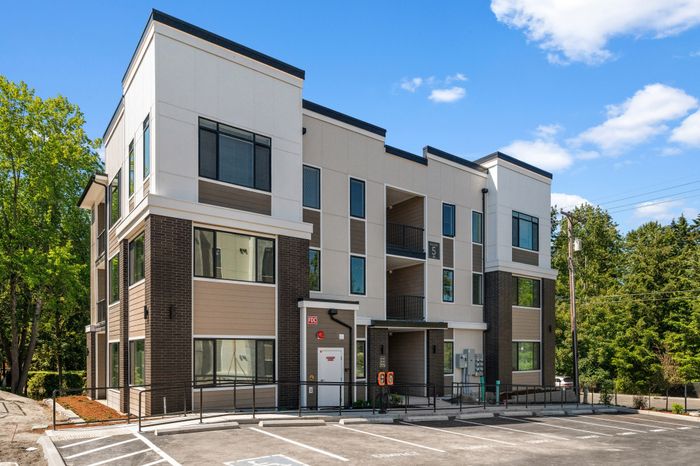 Modern exterior of the F Building at 27 West Apartments in University Place, featuring contemporary architecture and spacious 2-bedroom, 2-bath apartment homes.
