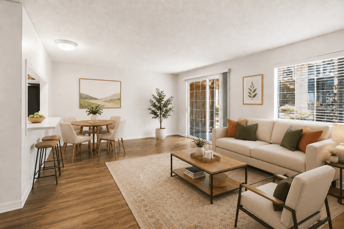 Inviting living room with natural light, elegant beige sofa, stylish decor, and dining area on sleek wooden flooring.