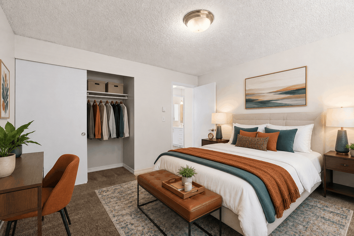 Inviting bedroom with cozy modern decor, featuring a plush bed, chic bedside tables, and an organized open closet.