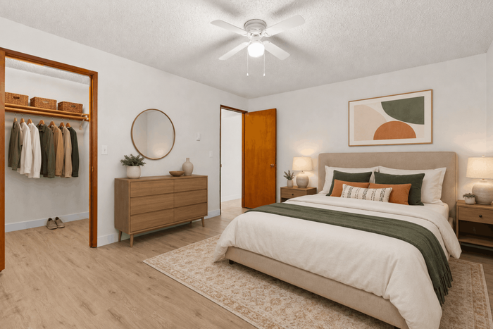 Inviting bedroom with modern decor, featuring a cozy bed, stylish wooden furniture, and a spacious walk-in closet.