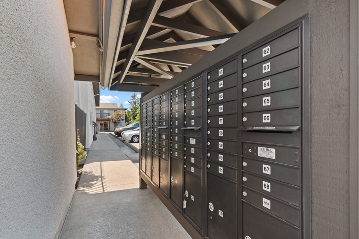 Modern apartment complex mailboxes under a stylish overhang with convenient access.