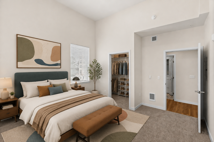 Elegant bedroom featuring a plush bed, stylish artwork, and a walk-in closet with ample storage space.