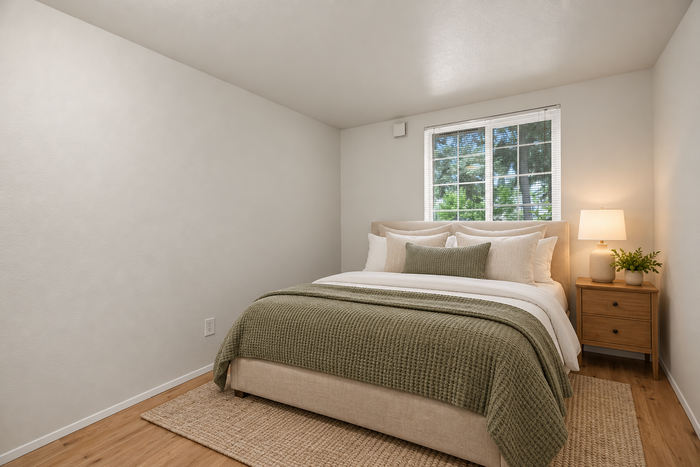 Inviting bedroom with elegant decor, plush bedding, and a soft, neutral color palette, featuring a cozy atmosphere and abundant natural light.