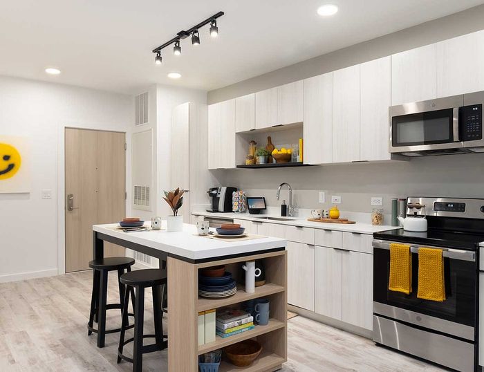 Modern kitchen with sleek cabinetry, stainless steel appliances, and a stylish island with seating.