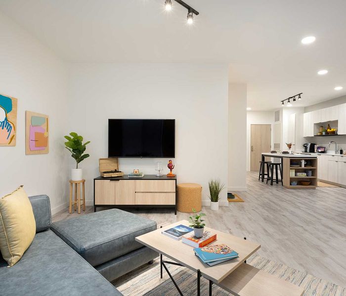 Modern living room and kitchen with sleek decor, open layout, and stylish furnishings for a chic city lifestyle.