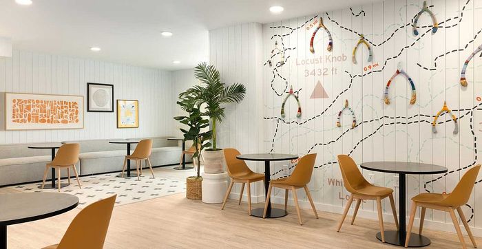 Chic lounge area with modern decor, featuring cozy seating, vibrant wall art, and elegant lighting for a relaxed ambiance.