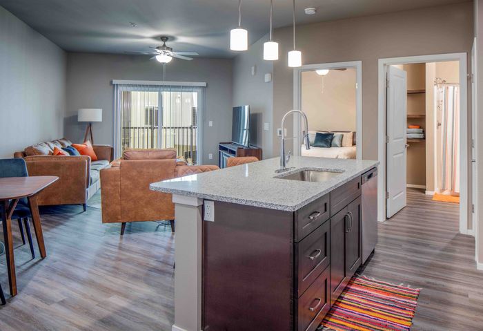 Promenade-Commons-Apartments-Rogers-Arkansas-Furnished-One-Bedroom-Kitchen-Living-Room-View