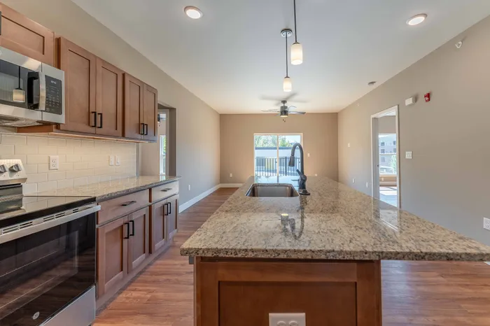 Township-28-Apartments-Springfield-Missouri-Building-H-Premium-Three-Bed-C-Kitchen-Island-Living-Room-View
