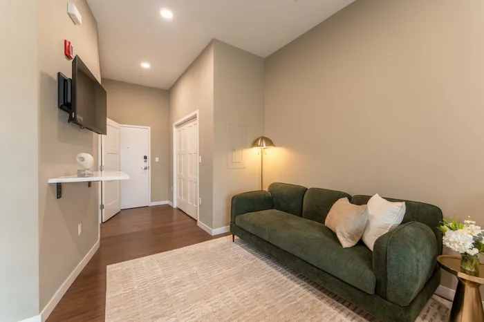 Heritage-Apartments-For-Rent-Springfield-Missouri-Furnished-Micro-Studio-Unit-405-Couch-And-Front-Entry