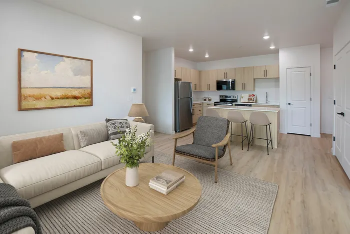 Inviting modern apartment living area with open kitchen, stylish decor, and elegant furnishings.