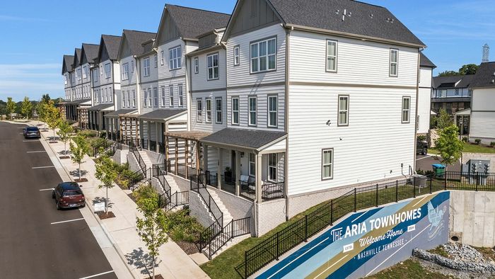 Charming Aria Townhomes displaying modern architecture with elegant porches and beautiful landscaping in Nashville, Tennessee.