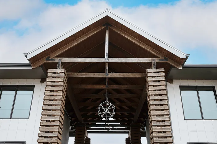 Architectural entrance and timber canopy at Wildwood Baton Rouge student apartments near LSU