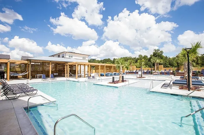Resort-style swimming pool and sun deck at Wildwood Baton Rouge student apartments near LSU
