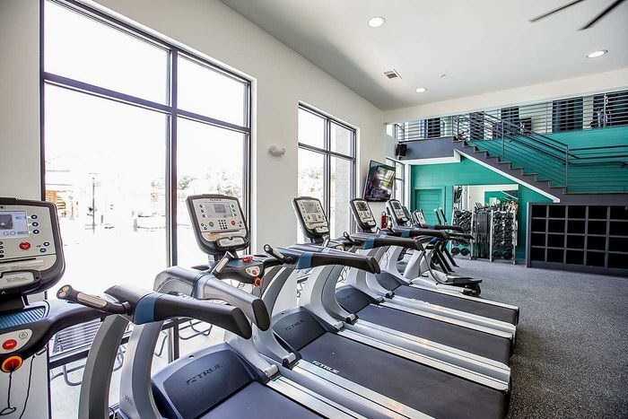 Cardio machines and treadmills inside the fitness center at Wildwood Baton Rouge student apartments near LSU