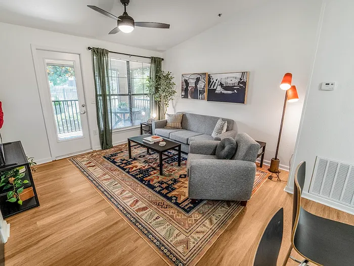 Deluxe apartment living room at The Lodge of Athens student housing with balcony and natural light