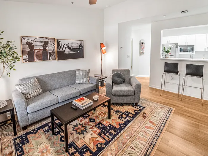 Modern living room with balcony inside a deluxe apartment at The Lodge of Athens student housing