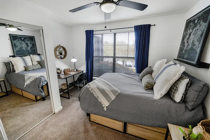 Spacious bedroom with desk and large window at The Lodge of Athens student apartments