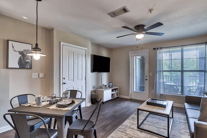 Open living and dining area with balcony at The Lodge of Athens student apartments