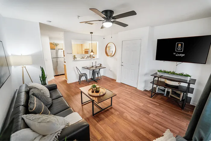 Open living room with dining area and kitchen at The Lodge of Athens student apartments