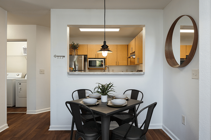 Dining area with kitchen pass-through at The Lodge of Athens student apartments