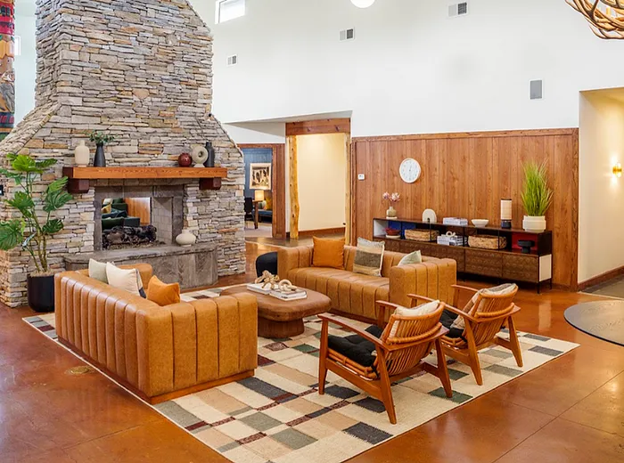 Clubhouse lounge at The Lodge of Athens with stone fireplace and seating area