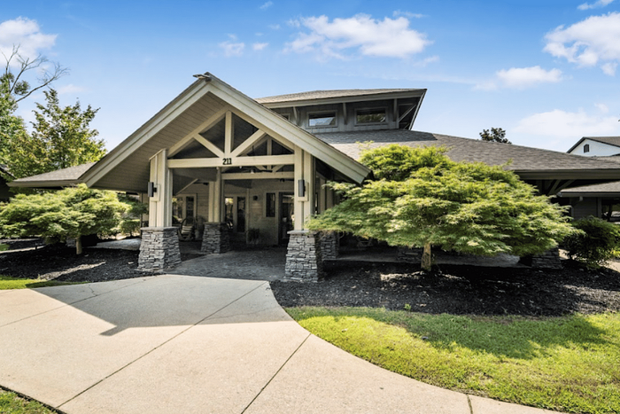 Entrance to The Lodge of Athens leasing office with landscaped grounds