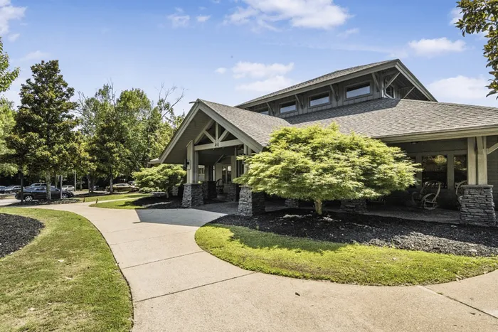 Exterior of The Lodge of Athens leasing office with landscaped walkway