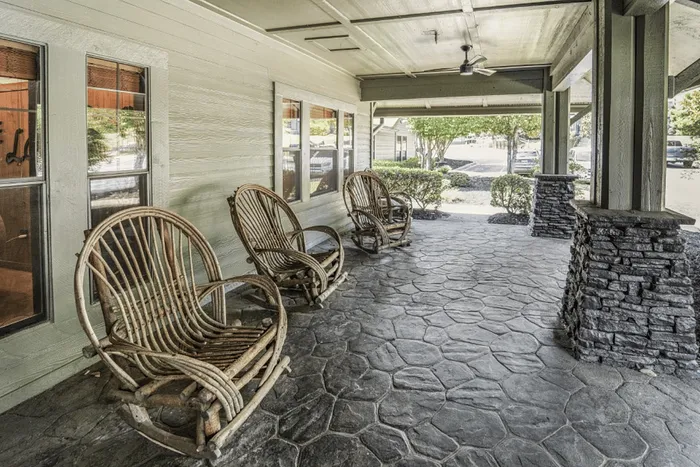 Covered porch with rocking chairs at The Lodge of Athens leasing office