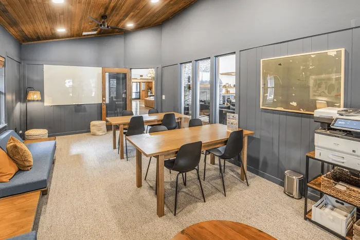 Study lounge with tables, seating, and printer at The Lodge of Athens