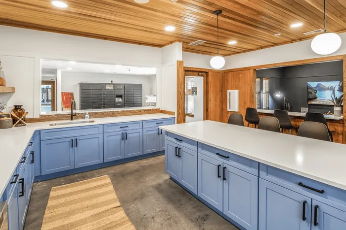 Resident kitchen and coworking area with island seating at The Lodge of Athens