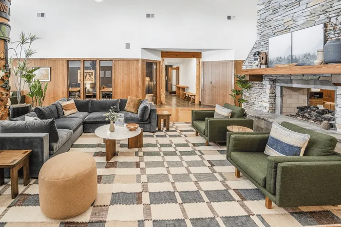 Resident lounge with stone fireplace and seating area at The Lodge of Athens
