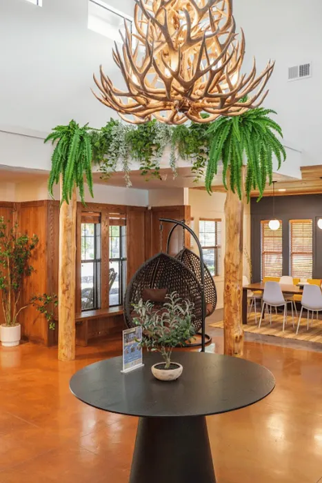 Rustic clubhouse interior at The Lodge of Athens with antler chandelier and lounge seating