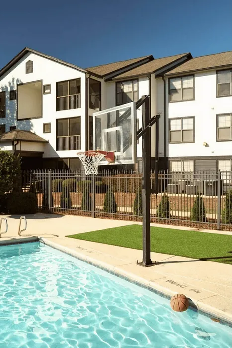 Resort-style swimming pool with poolside basketball hoop at The Lodge of Athens