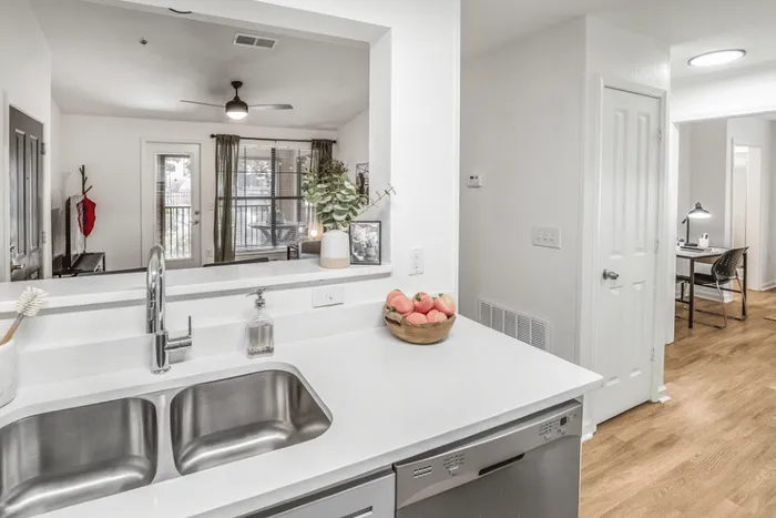 Open-concept kitchen and living room at The Lodge of Athens student apartments with breakfast bar