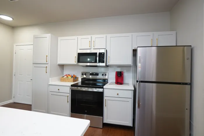 Sleek modern kitchen with white cabinetry, stainless steel appliances, and stylish countertops.