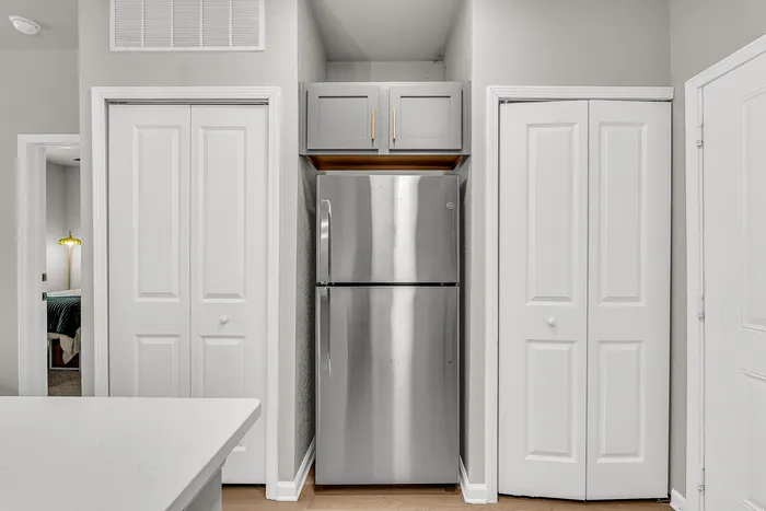 Modern kitchen with sleek stainless steel refrigerator, elegant cabinetry, and contemporary design.
