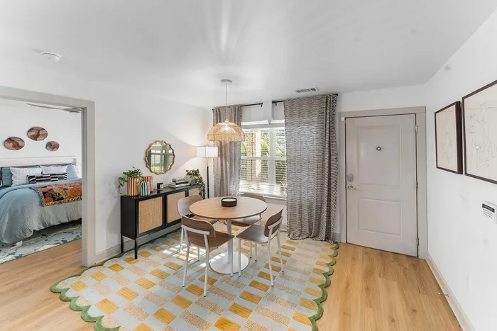 Dining area with natural light and bedroom entry at Wildwood Baton Rouge student apartments near LSU