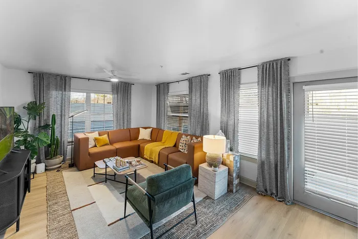 Spacious living room with sectional seating at Wildwood Baton Rouge student apartments near LSU