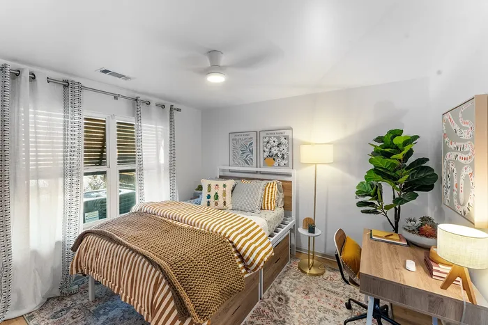 Furnished bedroom with study desk at Wildwood Baton Rouge student apartments near LSU