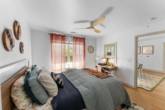 Furnished bedroom with study desk and large window at Wildwood Baton Rouge student apartments near LSU