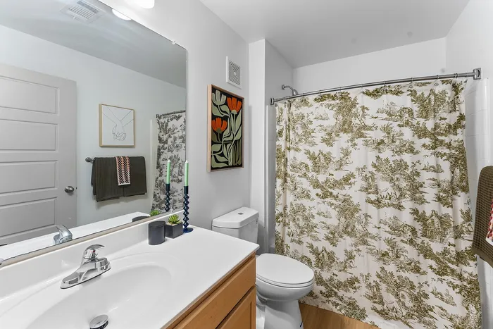 Private bathroom with tub and vanity at Wildwood Baton Rouge student apartments near LSU