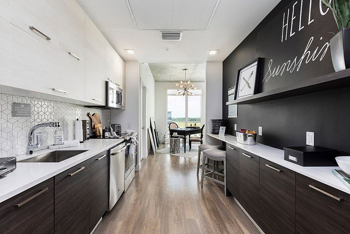 Modern open-concept kitchen with sleek cabinetry, stainless steel appliances, and a bright dining area with natural lighting.