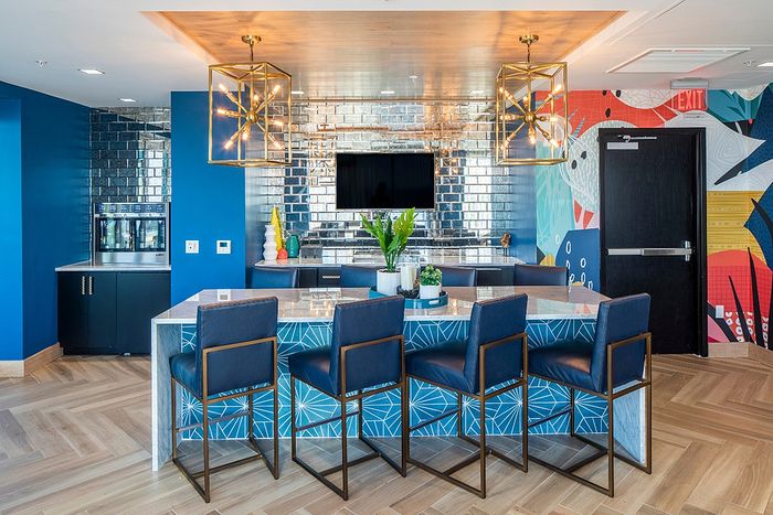 Vibrant and modern kitchen area with stylish bar seating, bold geometric patterns, and artistic wall decor.