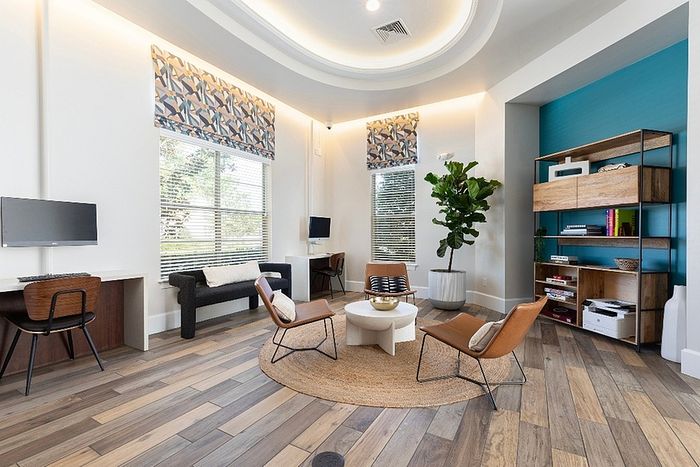 Inviting contemporary living room with modern furniture, large windows, and stylish decor, perfect for relaxation and work-from-home setup.