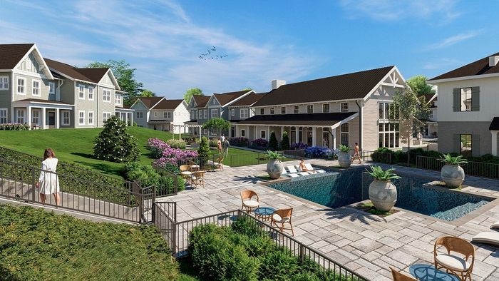 Beautiful community view showcasing charming townhouses with lush greenery, inviting pool area, and relaxing outdoor seating.