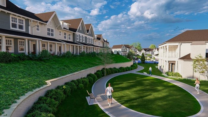 Charming suburban neighborhood with elegant townhouses, lush greenery, and a scenic walking path under a clear blue sky.