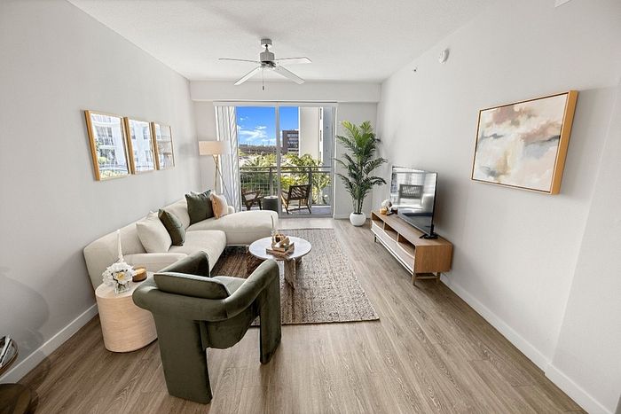 Bright and airy living room with chic decor, modern furniture, and a spacious balcony view.