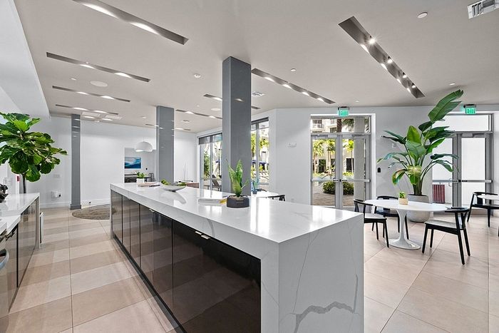 Modern open-concept living space with sleek marble countertops, elegant decor, and abundant natural light.