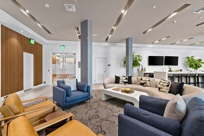 Modern and inviting lounge area with plush seating, sleek decor, and vibrant greenery, perfect for relaxation and socializing.